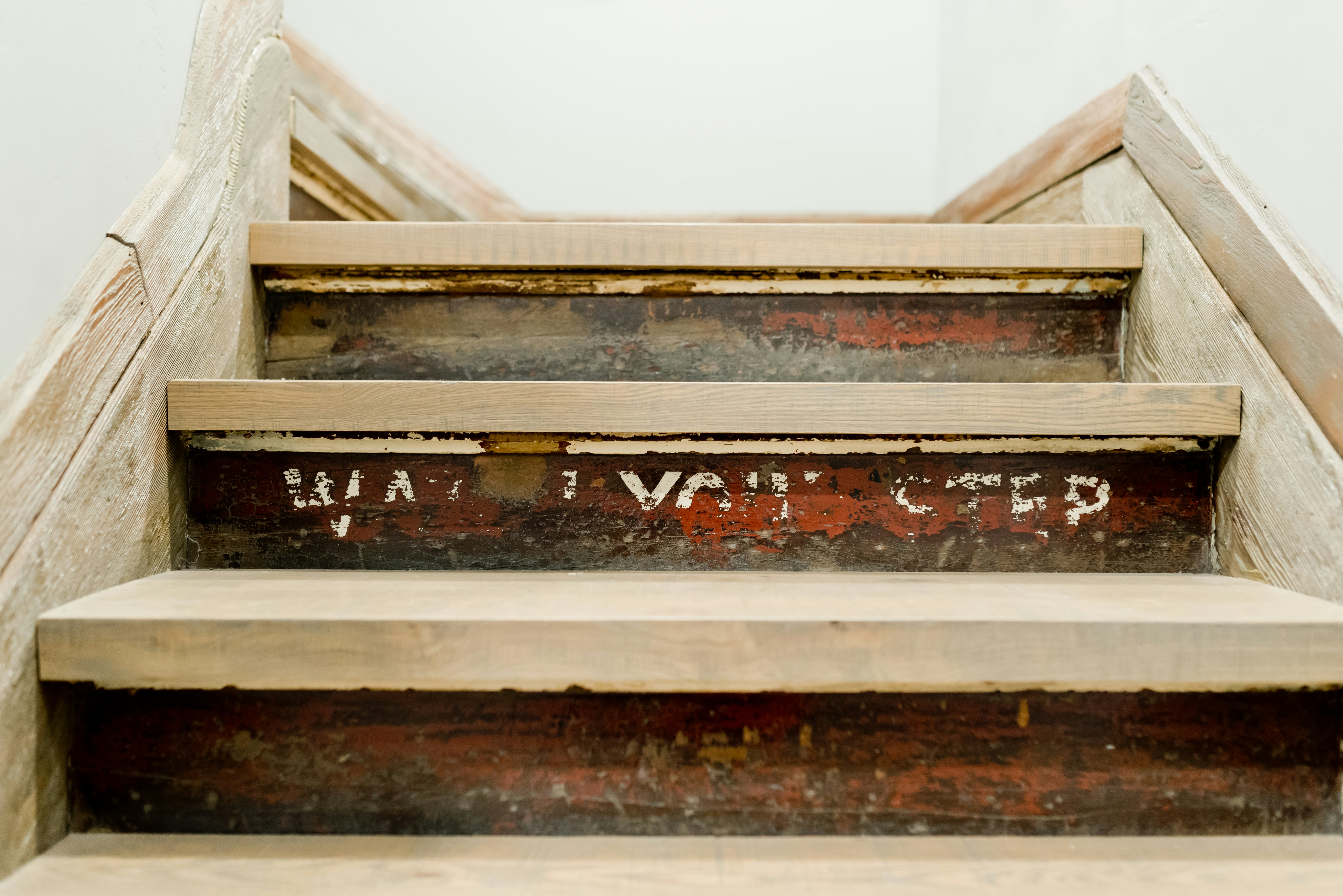 brown wooden staircase with white wooden railings